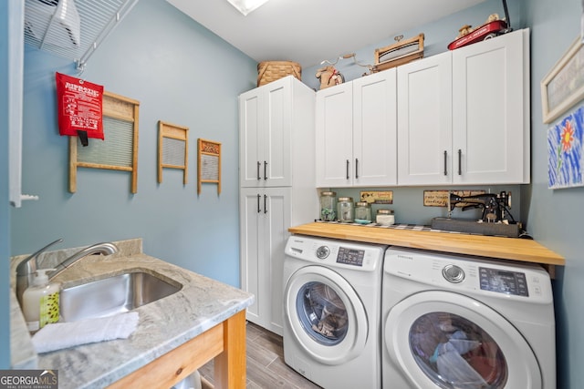 1280 Trinity Church Rd, Canton, GA 30115 - laundry area featuring separate washer and dryer, wood finished floors, and cabinet space