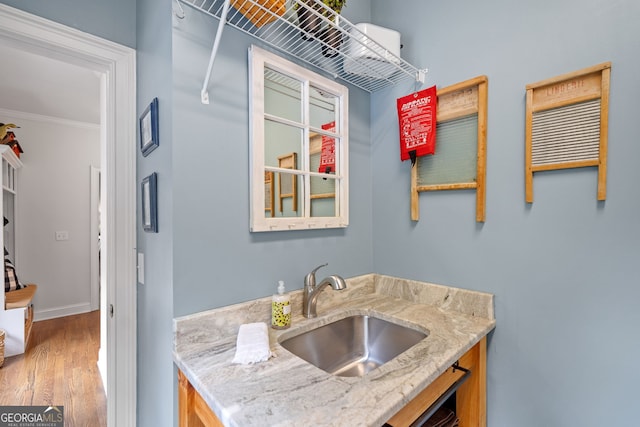 1280 Trinity Church Rd, Canton, GA 30115 - bar area featuring a sink, light wood finished floors, crown molding, and baseboards