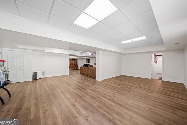 1280 Trinity Church Rd, Canton, GA 30115 - unfurnished living room with baseboards, wood finished floors, a tray ceiling, and a drop ceiling