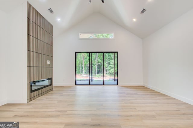 520 SW Rockbridge Rd SW, Lilburn, GA 30047 - unfurnished living room with high vaulted ceiling, light wood-type flooring, and recessed lighting