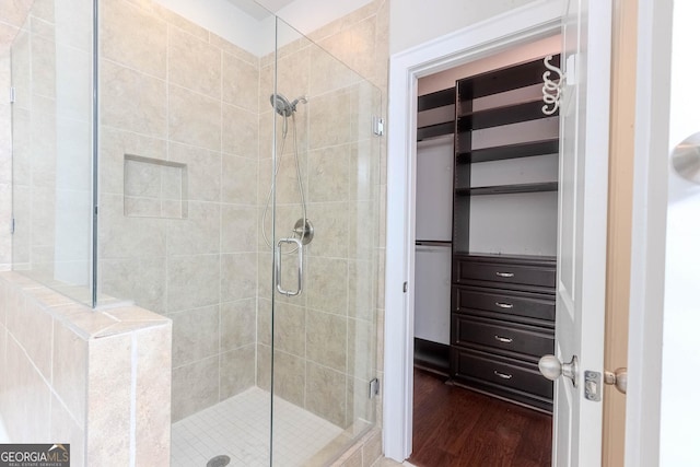 3758 Lake Haven Way, Atlanta, GA 30349 - bathroom featuring a shower stall, wood finished floors, and a walk in closet