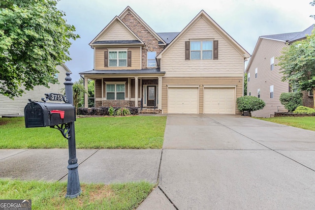 3758 Lake Haven Way, Atlanta, GA 30349 - craftsman-style home with a garage, a porch, a front yard, stone siding, and concrete driveway