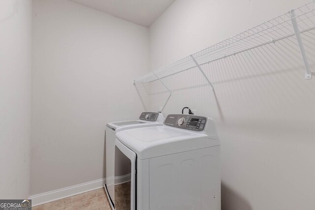 3758 Lake Haven Way, Atlanta, GA 30349 - laundry area featuring washing machine and clothes dryer and baseboards