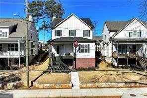 5924 Mitchell St, Flowery Branch, GA 30542 - view of front of house featuring a fenced front yard and brick siding