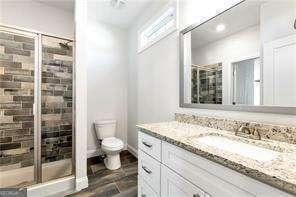 5924 Mitchell St, Flowery Branch, GA 30542 - bathroom featuring vanity, a stall shower, toilet, and recessed lighting