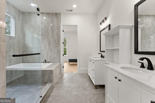 305 Etowah Cove Rd, Dahlonega, GA 30533 - bathroom featuring healthy amount of natural light, two vanities, and tiled bath