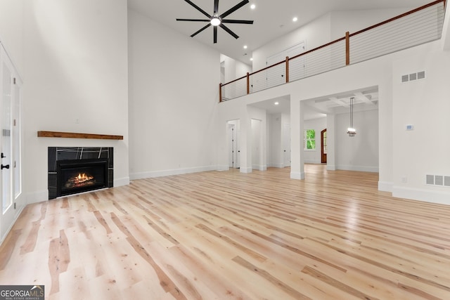 305 Etowah Cove Rd, Dahlonega, GA 30533 - unfurnished living room with wood finished floors, a high ceiling, a fireplace, recessed lighting, and baseboards