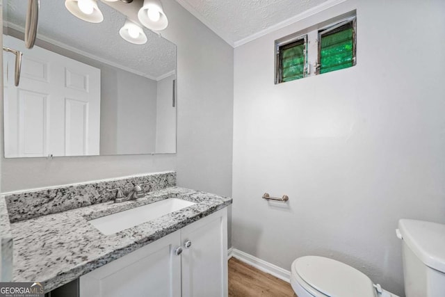 2078 Olive Springs Rd SE, Marietta, GA 30060 - half bath with toilet, wood finished floors, vanity, a textured ceiling, and baseboards