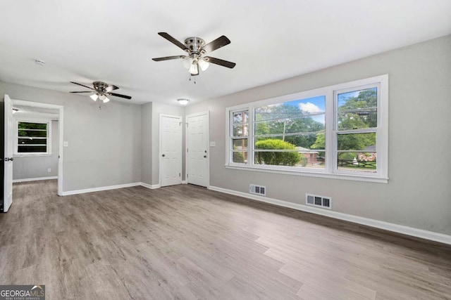 2078 Olive Springs Rd SE, Marietta, GA 30060 - unfurnished living room with baseboards, a ceiling fan, and wood finished floors