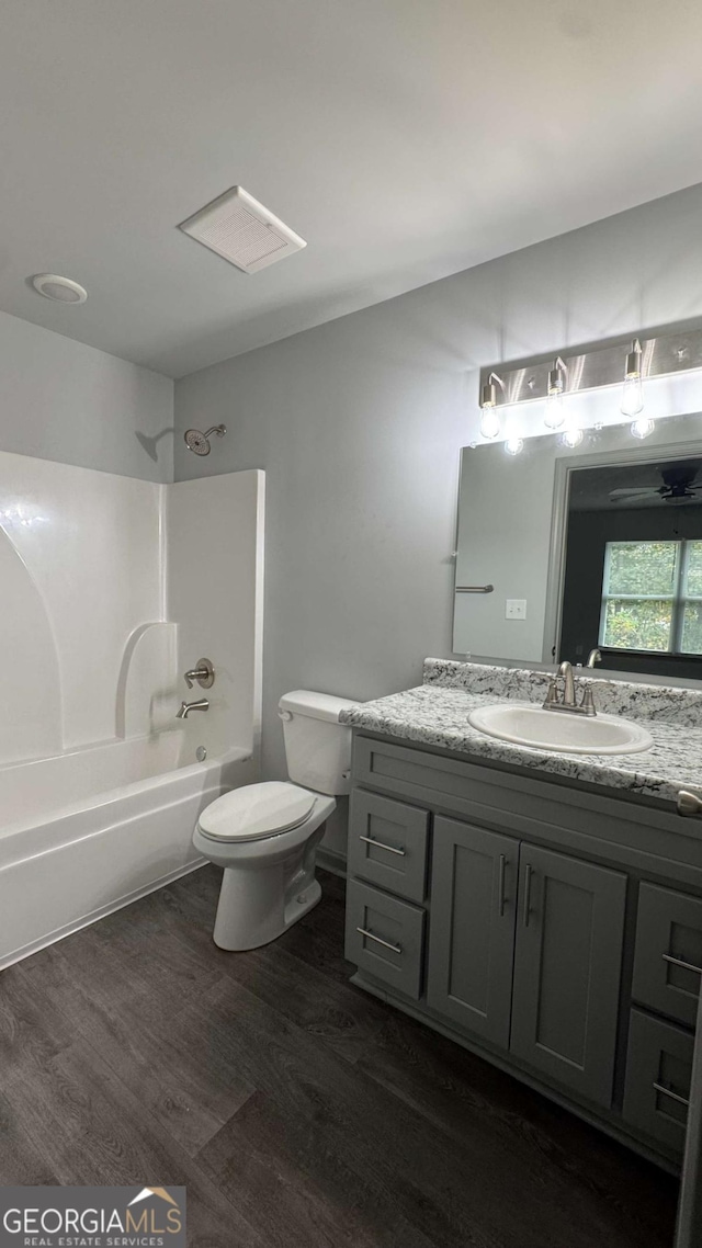 3204 Fairington Village Dr, Lithonia, GA 30038 - bathroom with wood finished floors, vanity, and tub / shower combination