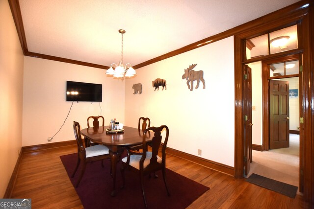 175 Corbin Ave Apt B, Macon, GA 31204 - dining area with a chandelier, crown molding, and wood finished floors