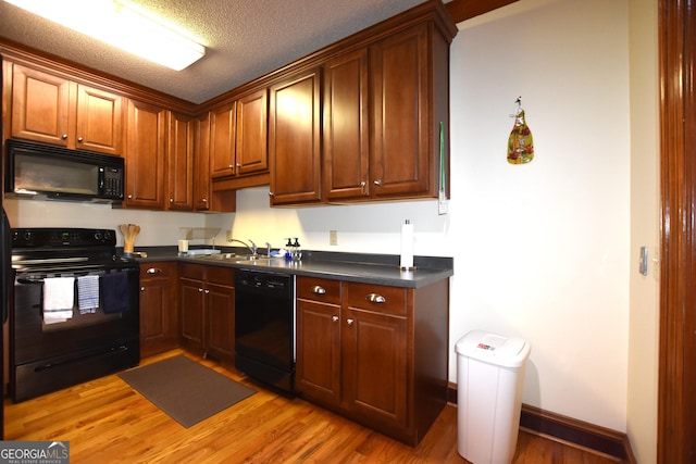 175 Corbin Ave Apt B, Macon, GA 31204 - kitchen with black appliances, dark countertops, and light wood-type flooring