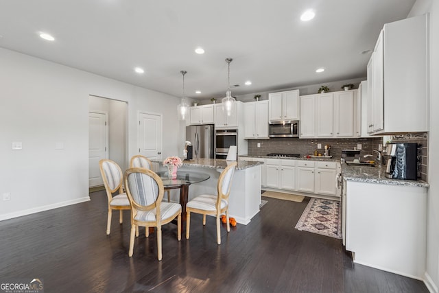 3755 Gardenside Ct, Alpharetta, GA 30004 - kitchen featuring stainless steel appliances, baseboards, backsplash, dark wood-type flooring, and white cabinets