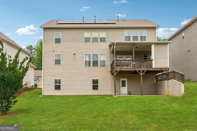 3755 Gardenside Ct, Alpharetta, GA 30004 - rear view of house with roof mounted solar panels, a lawn, and a balcony