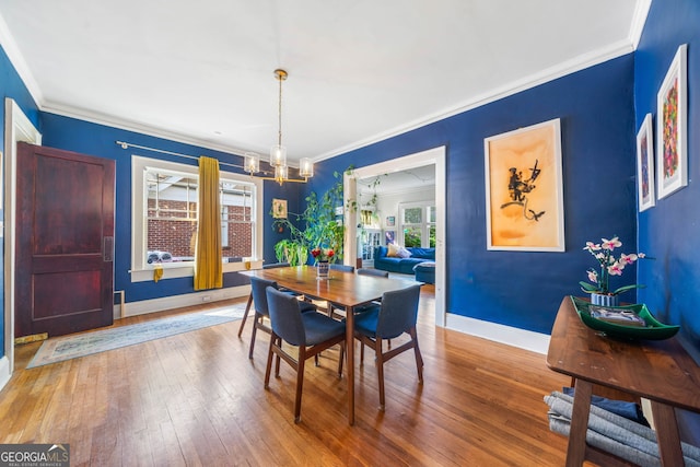 451 S Columbia Dr, Decatur, GA 30030 - dining space featuring a chandelier, ornamental molding, hardwood / wood-style floors, and baseboards
