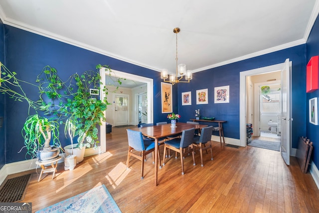 451 S Columbia Dr, Decatur, GA 30030 - dining room with a chandelier, light wood-style flooring, baseboards, and ornamental molding