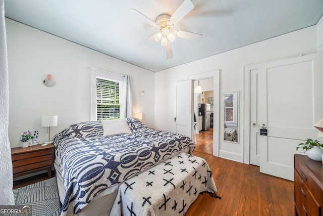 451 S Columbia Dr, Decatur, GA 30030 - bedroom featuring freestanding refrigerator, dark wood finished floors, and ceiling fan
