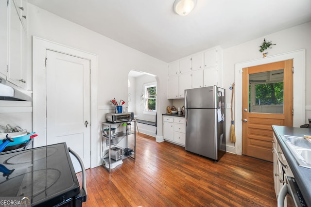 451 S Columbia Dr, Decatur, GA 30030 - kitchen with freestanding refrigerator, electric range oven, arched walkways, and white cabinets