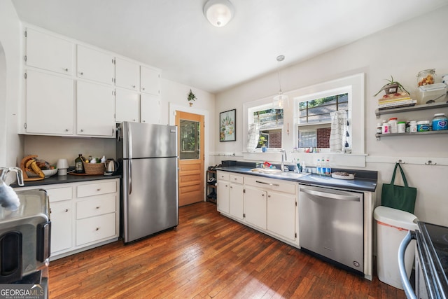 451 S Columbia Dr, Decatur, GA 30030 - kitchen with appliances with stainless steel finishes, a sink, dark countertops, white cabinets, and dark wood-type flooring