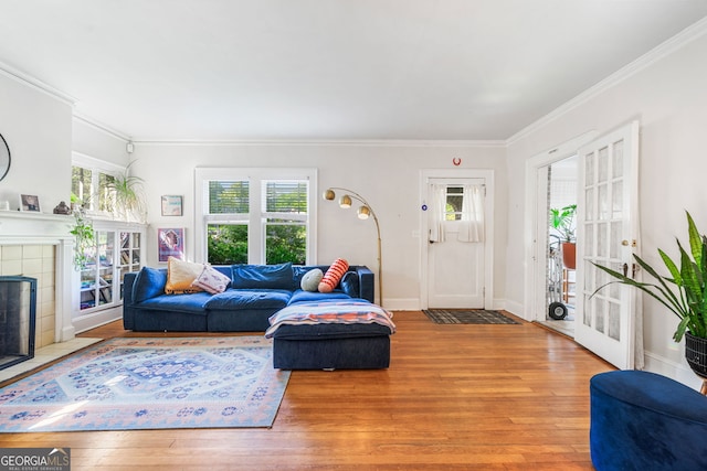 451 S Columbia Dr, Decatur, GA 30030 - living area featuring wood-type flooring, plenty of natural light, crown molding, a tiled fireplace, and baseboards