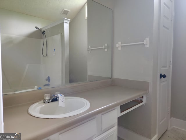 70 Priscilla Way, Newnan, GA 30265 - bathroom featuring vanity, a shower, and a textured ceiling