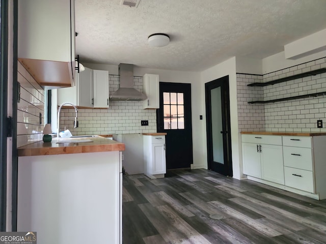 70 Priscilla Way, Newnan, GA 30265 - kitchen with wall chimney exhaust hood, butcher block counters, a sink, backsplash, and a textured ceiling