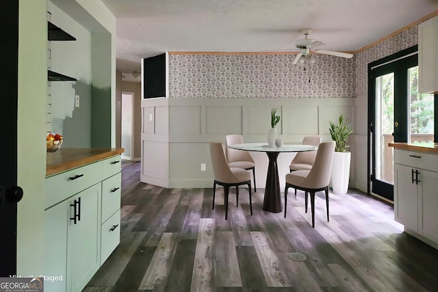 70 Priscilla Way, Newnan, GA 30265 - dining area featuring wallpapered walls, a ceiling fan, a decorative wall, dark wood finished floors, and a wainscoted wall