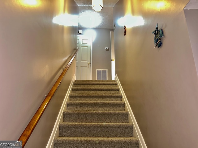 3272 Horace Rd, Bowman, GA 30624 - stairs featuring a textured ceiling and baseboards