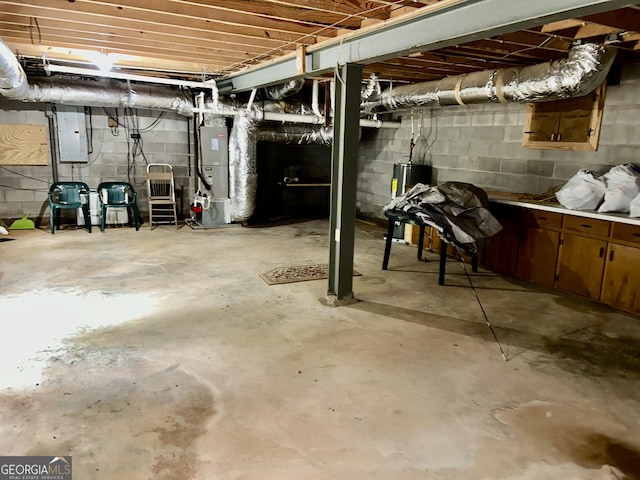 3272 Horace Rd, Bowman, GA 30624 - unfinished below grade area with electric panel, heating unit, concrete block wall, and water heater