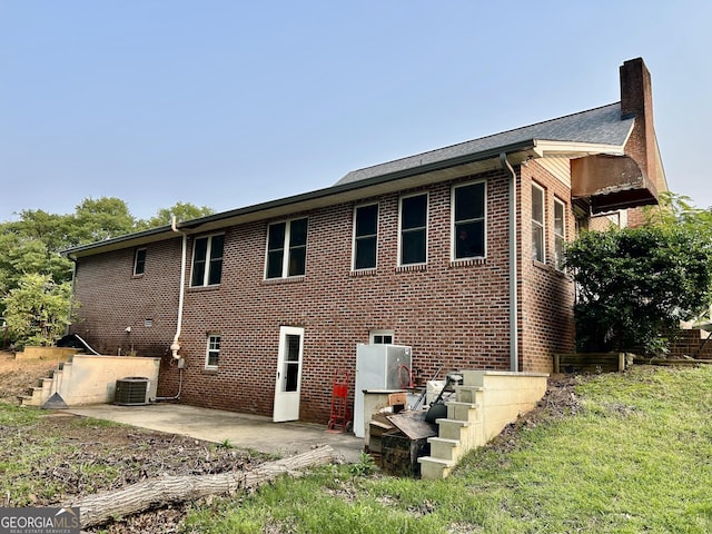3272 Horace Rd, Bowman, GA 30624 - back of property featuring brick siding, a patio, a chimney, and central AC unit