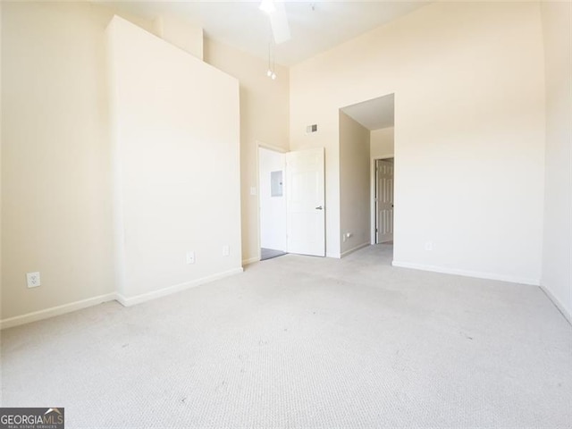 200 Renaissance Pkwy NE Unit 310, Atlanta, GA 30308 - unfurnished room featuring light carpet, a high ceiling, and electric panel