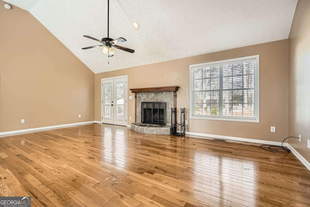 13 Cliff Ct, Villa Rica, GA 30180 - unfurnished living room with ceiling fan, wood-type flooring, a fireplace, a textured ceiling, and high vaulted ceiling