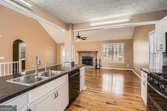 13 Cliff Ct, Villa Rica, GA 30180 - kitchen featuring lofted ceiling, black dishwasher, range with two ovens, ceiling fan, and open floor plan