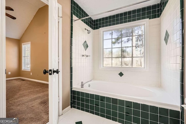 13 Cliff Ct, Villa Rica, GA 30180 - bathroom with vaulted ceiling, ceiling fan, and tiled shower / bath