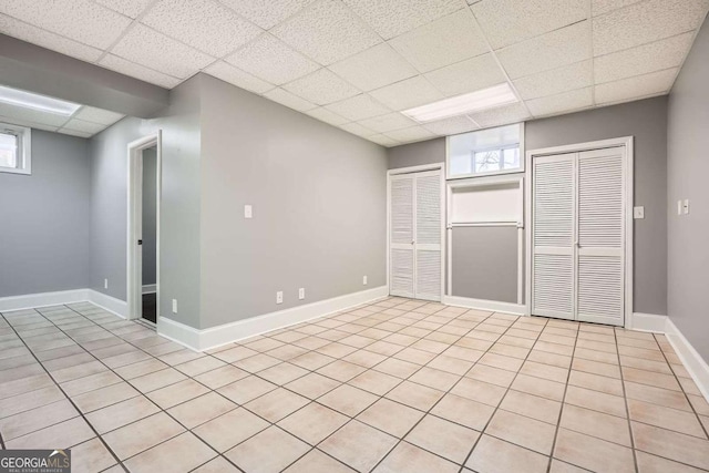 13 Cliff Ct, Villa Rica, GA 30180 - unfurnished room featuring a paneled ceiling, plenty of natural light, and light tile patterned floors