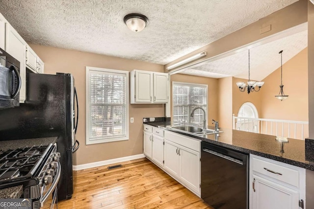 13 Cliff Ct, Villa Rica, GA 30180 - kitchen with black appliances, a textured ceiling, white cabinets, light wood-type flooring, and a chandelier