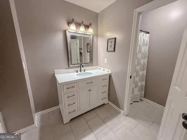 653 Al Roberts Rd, Senoia, GA 30276 - bathroom with vanity, tile patterned floors, baseboards, and a shower with shower curtain