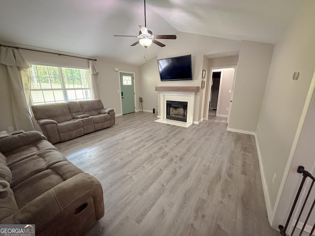 653 Al Roberts Rd, Senoia, GA 30276 - living area featuring a ceiling fan, a fireplace with flush hearth, baseboards, wood finished floors, and vaulted ceiling