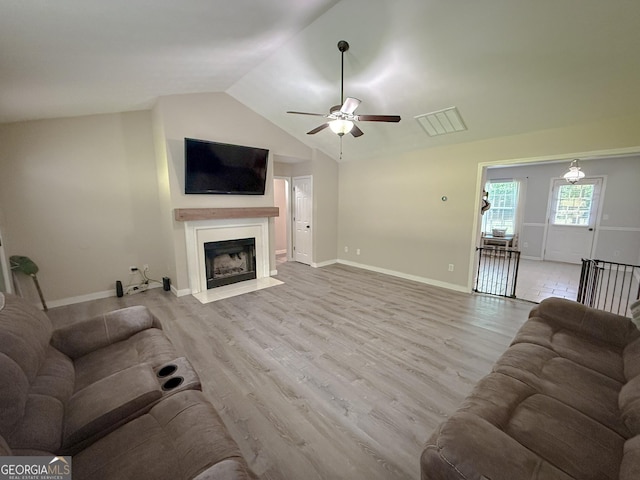 653 Al Roberts Rd, Senoia, GA 30276 - living area with ceiling fan, lofted ceiling, a fireplace with flush hearth, wood finished floors, and baseboards