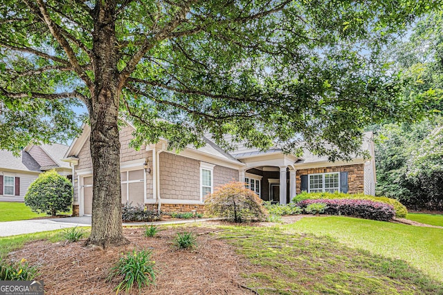 4445 Vanadium Bnd, Cumming, GA 30040 - view of front of home with stone siding, a garage, a front yard, and driveway