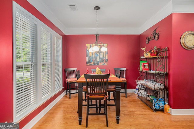 4445 Vanadium Bnd, Cumming, GA 30040 - dining space featuring a chandelier, light wood-type flooring, ornamental molding, and baseboards