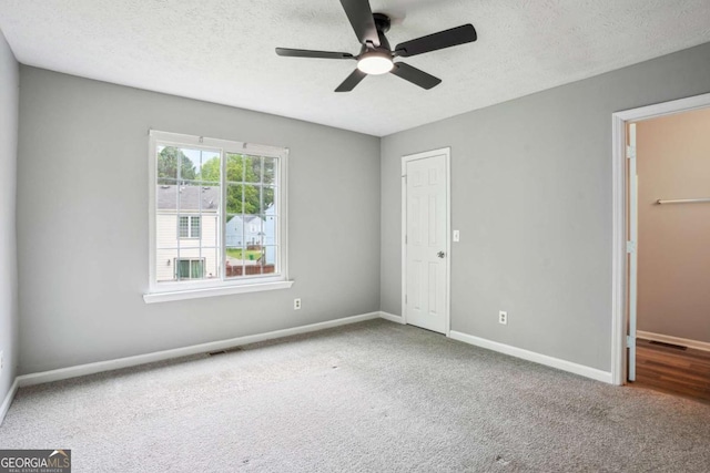 2049 Charter Ln, Lithonia, GA 30058 - unfurnished bedroom with carpet flooring, a textured ceiling, a closet, and ceiling fan