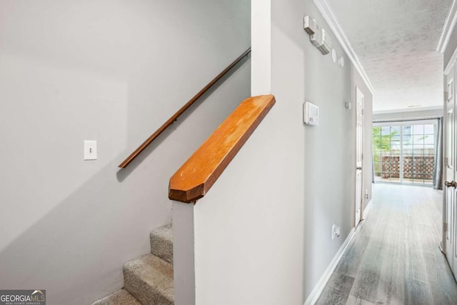 2049 Charter Ln, Lithonia, GA 30058 - stairs featuring wood finished floors, ornamental molding, baseboards, and a textured ceiling