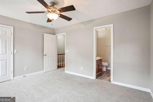 2049 Charter Ln, Lithonia, GA 30058 - unfurnished bedroom with carpet floors, connected bathroom, a ceiling fan, and a textured ceiling