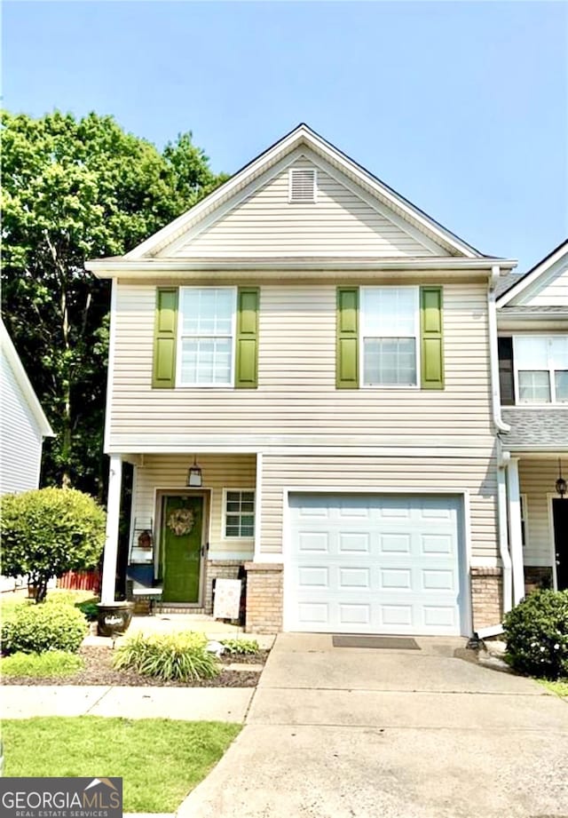 4863 Beacon Ridge Ln, Flowery Branch, GA 30542 - view of front of house with a garage, a porch, brick siding, and driveway
