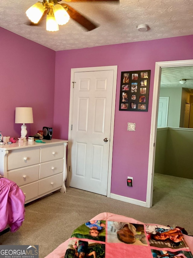 4863 Beacon Ridge Ln, Flowery Branch, GA 30542 - bedroom featuring light colored carpet, a textured ceiling, and ceiling fan
