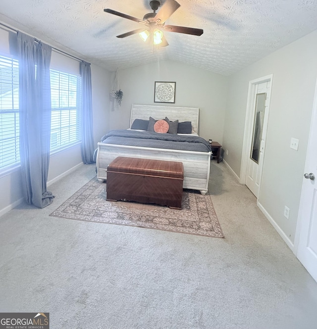 4863 Beacon Ridge Ln, Flowery Branch, GA 30542 - bedroom with carpet flooring, a textured ceiling, baseboards, lofted ceiling, and a ceiling fan