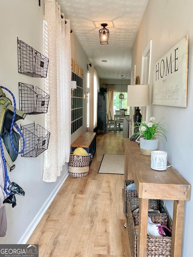 4863 Beacon Ridge Ln, Flowery Branch, GA 30542 - corridor featuring light wood-type flooring and baseboards