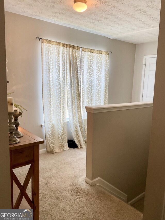 4863 Beacon Ridge Ln, Flowery Branch, GA 30542 - corridor featuring carpet floors, a textured ceiling, and baseboards