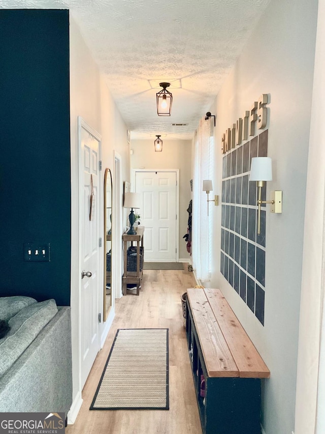 4863 Beacon Ridge Ln, Flowery Branch, GA 30542 - entryway featuring wood finished floors and a textured ceiling